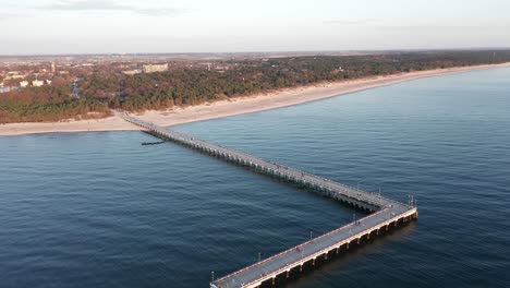 AERIAL:-Revealing-Palanga-City-on-Golden-Hour-with-Palanga-Bridge-in-Foreground