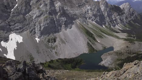 Mountain-lake-pan-to-hiker-watching-waiting-Rockies-Kananaskis-Alberta-Canada