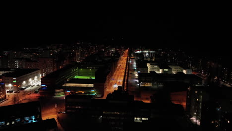 Aerial-view-over-a-lit-up-streets-in-Lauttasaari,-winter-night-in-Helsinki,-Finland