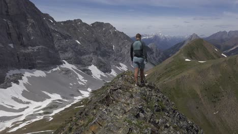 Hiker-on-mountain-ridge-walking-followed-Rockies-Kananaskis-Alberta-Canada