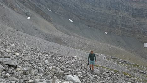 Hiker-looking-up-mountain-rocks-Rockies-Kananaskis-Alberta-Canada