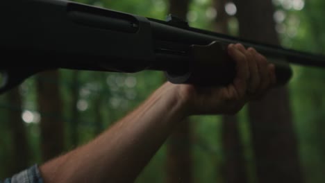 close-up-shotgun-shooting-in-slow-motion-caucasian-male-hand-embracing-weapon-slow-motion-pull-the-trigger
