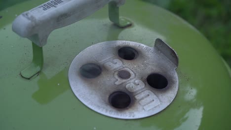 Closeup-Of-Smoke-Hole-On-The-Cover-Of-Weber-Kettle-Grill