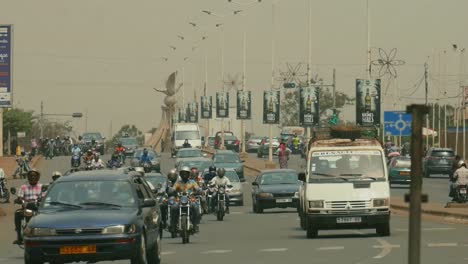 Busy-arfican-city-road-with-incoming-cars-and-motorcycles---Togo,-Africa