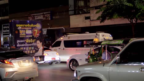Ambulance-stuck-on-traffic-road-at-night-in-downtown-Bangkok