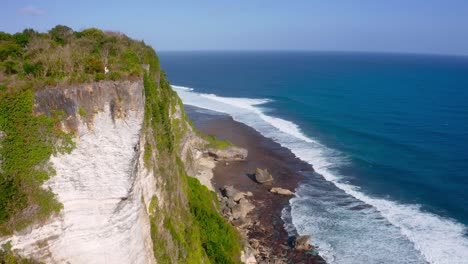 Aerial-shot-of-beautiful-Karang-Boma-cliff-in-Indonesia-on-a-sunny-day-with-blue-skies