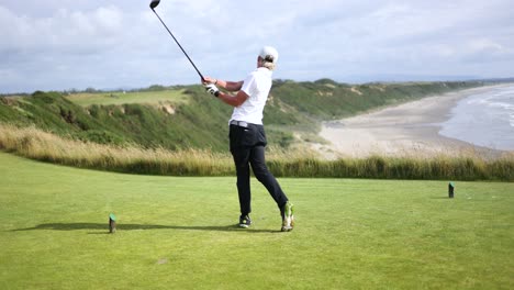 Talented-Young-Golfer-Teeing-Off-on-Tee-Box-on-Coastline-Golf-Course