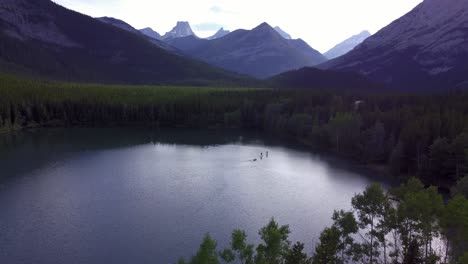 Paddle-boards-boat-on-pond-in-mountains-approached-Rockies-Kananaskis-Alberta-Canada