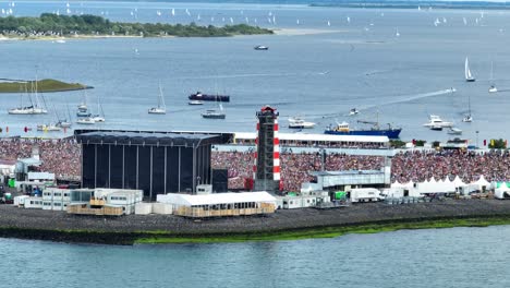 Thousands-of-people-attend-the-annual-concert-at-sea-in-Brouwersdam,-Holland