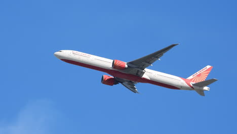 Indian-transport-Boeing-painted-red-takes-off-from-a-Canadian-airport-on-a-blue-sky-day