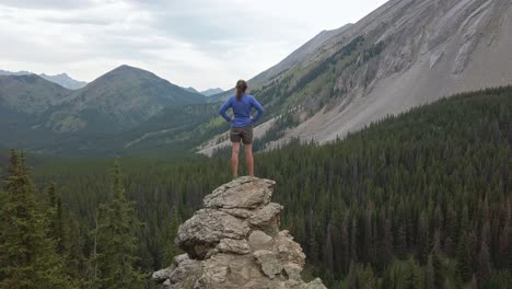 Hiker-standing-on-ledge-enjoying-the-view-Rockies-Kananaskis-Alberta-Canada