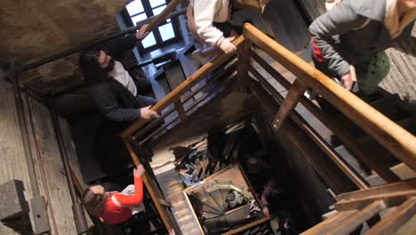 Walking-up-the-stairs-of-famous-Asinelli-tower-with-tourists-in-Bologna,-Italy