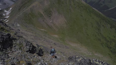 Hiker-walking-carefully-down-the-mountain-ridge-Rockies-Kananaskis-Alberta-Canada