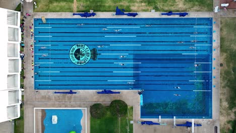 Athletes-Competing-in-Outdoor-Swimming-Race,-Aerial-Top-Down-View