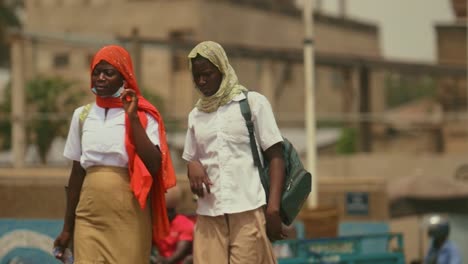 Two-Muslim-Female-Students-Wearing-Veil-in-African-City-Street---Lomé,-Togo