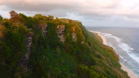 Woman-standing-on-edge-of-tertiary-limestone-Uluwatu-Cliffs