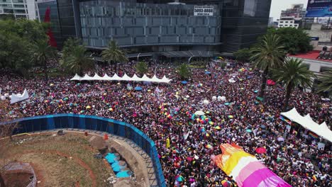 Aerial-view-overlooking-tons-of-people-partying-at-the-Gay-pride-parade-in-Mexico-city---rising,-drone-shot