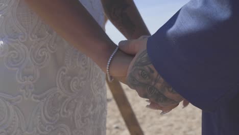 Bride-and-groom-holding-hands-at-ceremony