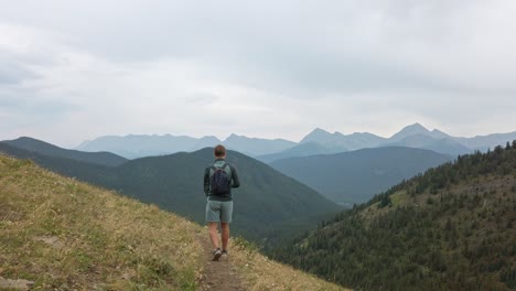 Hiker-walking-on-a-trail-in-high-altitude-Rockies-Kananaskis-Alberta-Canada