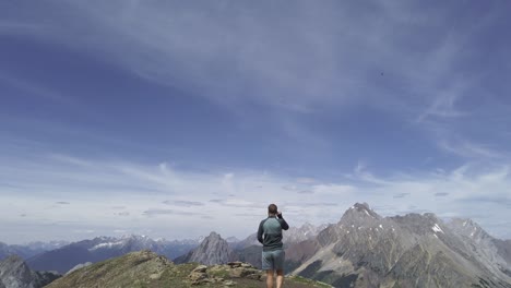 Hiker-walking-on-top-of-ridge-following-Rockies-Kananaskis-Alberta-Canada