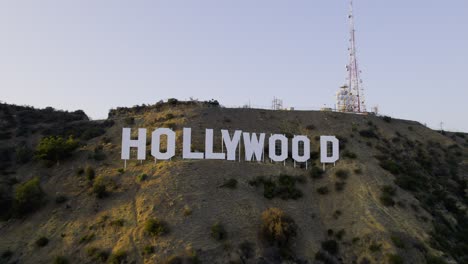 Aerial-view-approaching-the-Hollywood-sign,-sunny-evening-in-Los-Angeles,-USA