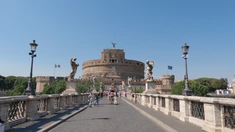 Castel-Sant'Angelo-from-the-Aelian-bridge-in-Rome,-tourists-cross-bridge-from-Mausoleum-of-Hadrian