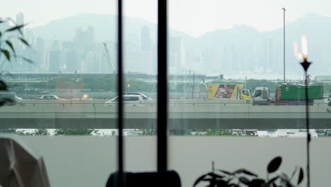Hongkong--August-03,-2022:-buses,-trucks-and-cars-passing-over-the-flyover,-view-from-the-apartment-window