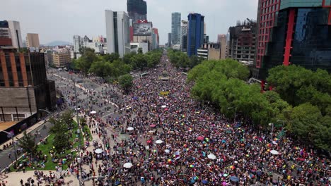 Downtown-Mexico-city-full-of-people-celebrating-gay-pride---tilt,-aerial-view