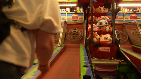 A-person-tries-their-luck-playing-skee-ball-during-a-fun-evening-at-the-carnival