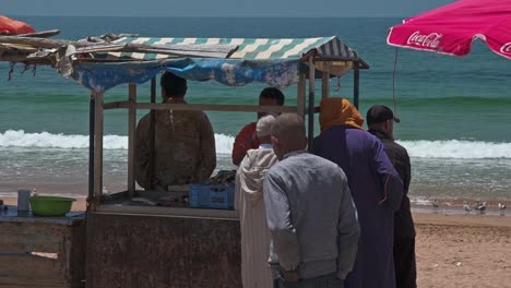Fishermen-around-a-fishing-booth-in-Taghazout's-beach
