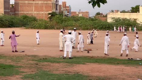 A-static-shot-of-many-little-boys-from-Islamic-community-playing-games-and-enjoying-togetherness-at-a-ground