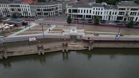 Aerial-descent-showing-the-quay-at-river-IJssel-with-work-in-progress-on-the-IJsselkade-boulevard-of-tower-town-Zutphen-urban-development