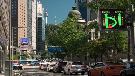 Cars-in-Heavy-traffic-in-the-old-town-of-Seoul-downtown-with-Namsan-tower-view-behind-buildings