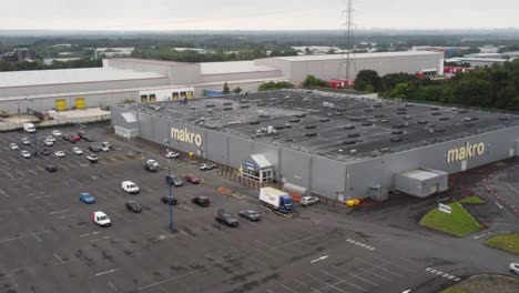 Aerial-view-makro-cash-and-carry-wholesale-supermarket-store-exterior-orbiting-right
