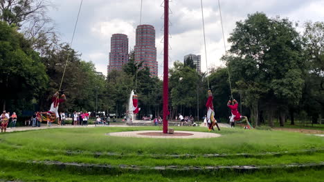 slow-motion-scene-of-some-voladores-de-papantla-in-the-Chapultepec-forest-of-Mexico-city