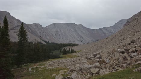 Hikers-in-distance-inside-Mountain-Valley-approached-Rockies-Kananaskis-Alberta-Canada