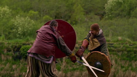 Vikings-battle-with-swords-and-shields-in-a-fight-wearing-historical-costumes---slow-motion