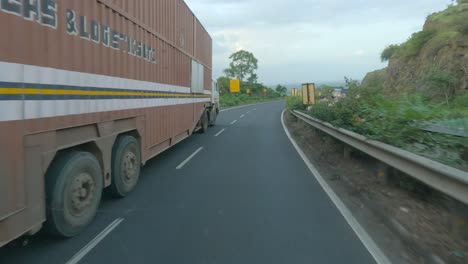A-point-of-view-shot-of-a-driver-overtaking-a-freight-lorry-truck-on-a-four-lane-National-Mumbai-Agra-highway