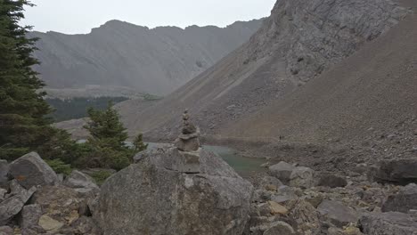Cairn-rock-hikers-in-the-background-pan-Rockies-Kananaskis-Alberta-Canada