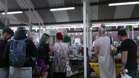 People-browsing-budget-affordable-goods-on-British-outdoor-market-during-cost-of-living-crisis