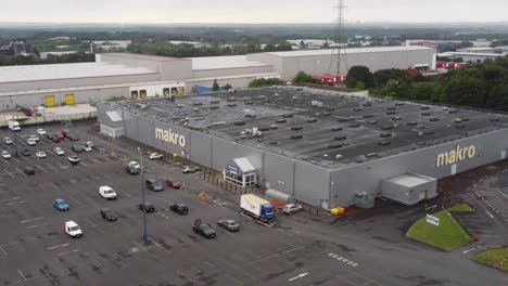 Aerial-view-makro-cash-and-carry-wholesale-supermarket-store-exterior-flyover