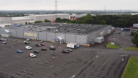 Aerial-view-makro-cash-and-carry-wholesale-supermarket-store-exterior-zoom-in-shot