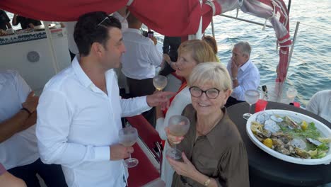 Guests-on-a-wedding-party-at-sea-enjoying-themselves-with-champagne-and-sea-food