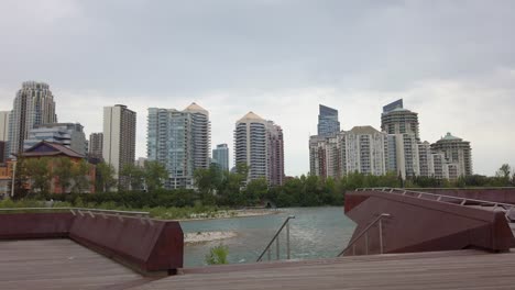City-skyscraper-skyline-from-a-deck-by-river-circling-Memorial-Drive-Monument-Calgary-Alberta-Canada
