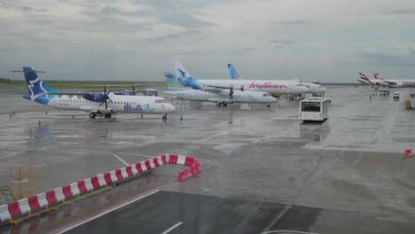 Velana-international-airport-in-Male-on-a-busy-cloudy-day-with-buses-and-airplanes-parked-outside
