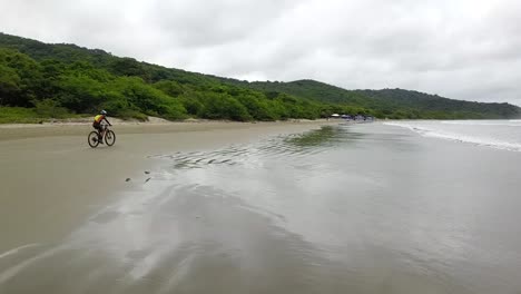 beach-biker,-nicaragua,-san-juan-sur,-mtb-competition-on-the-beach,-nicaragua,-mtb-competition-on-the-beach,-aerial-video,-biking