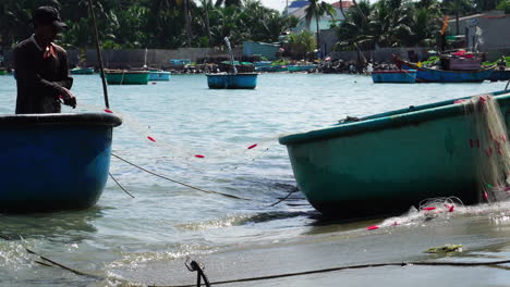 Fisherman-sorting-a-net-from-one-boat-to-another