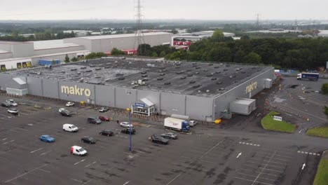 Aerial-rising-forward-view-makro-cash-and-carry-wholesale-supermarket-store-exterior