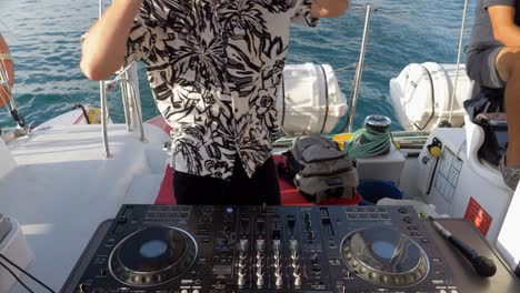 DJ-playing-music-on-a-Catamaran-sail-boat-for-a-wedding-party
