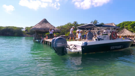 General-shot-of-a-Speedboat-in-the-ocean-arriving-at-a-crowded-private-island-Dock-in-Cartagena-Colombia-in-a-sunny-day
